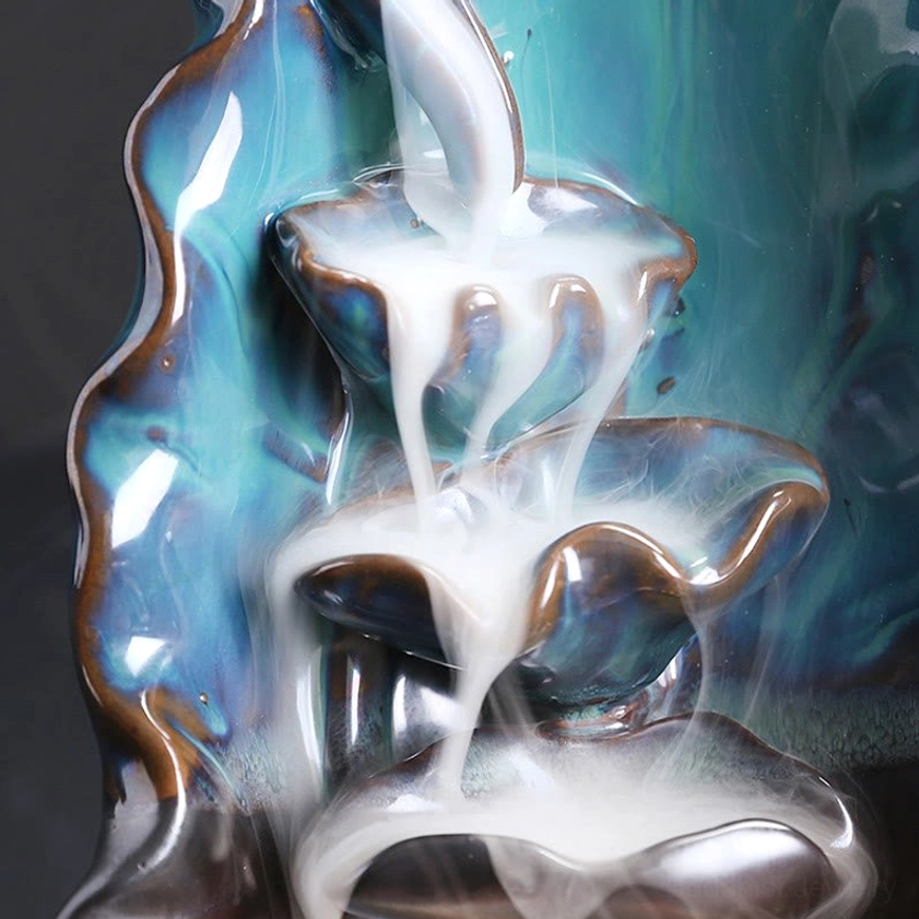 Close-up front view of backflow smoke structure showing glossy teal ceramic lotus tiers and multi-tiered design for smoke cascade