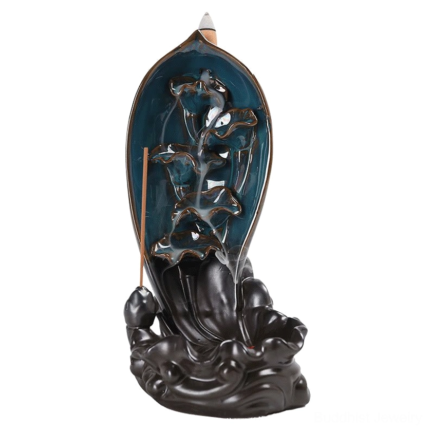 Lotus backflow incense burner with teal glazed lotus design and dark brown wave base featuring inserted stick incense on white background