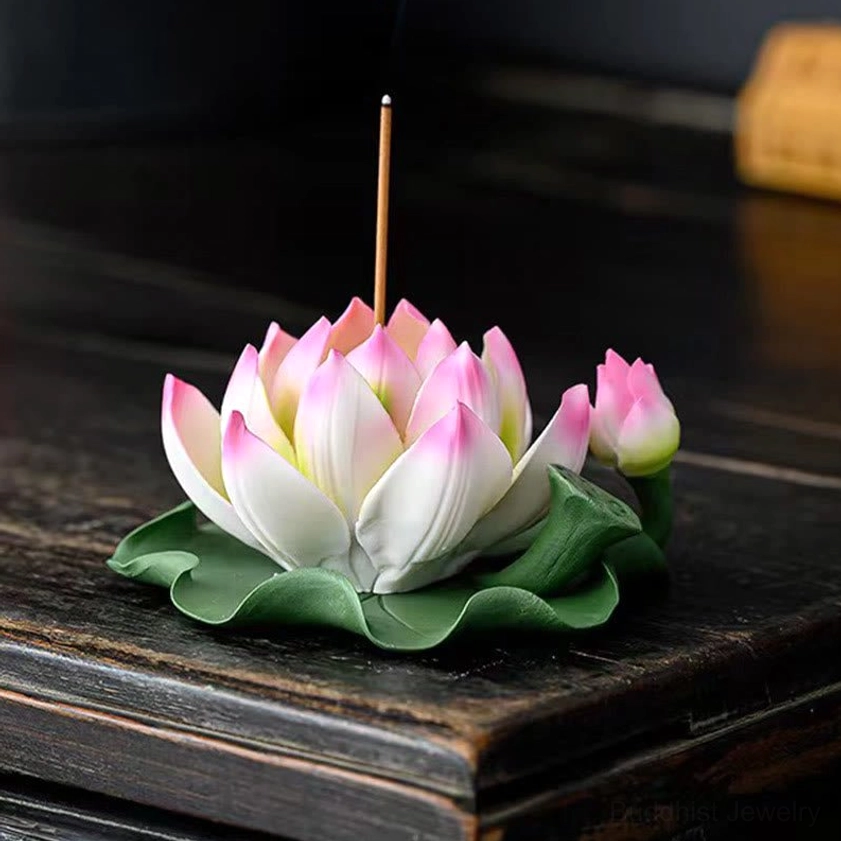 Gradient pink-white lotus incense burner with standing incense stick and green leaf base