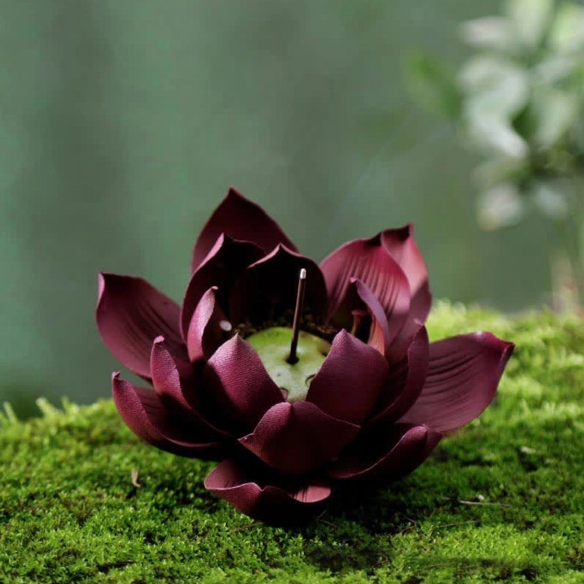 Three-quarter view of lotus-shaped purple clay incense holder showing detailed green center seed pod and smoking incense stick