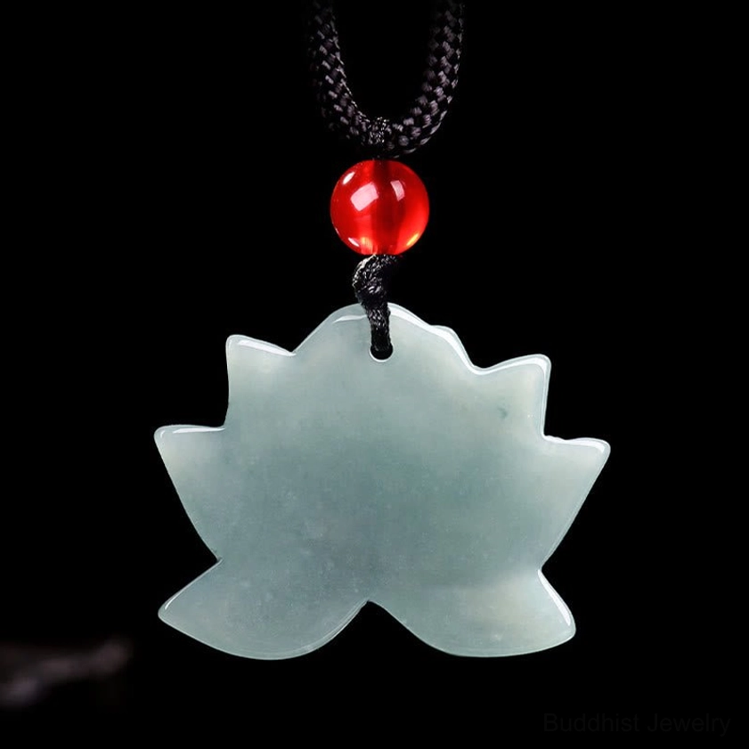 Back of lotus jade pendant showing uncarved smooth surface with red bead and black cord necklace