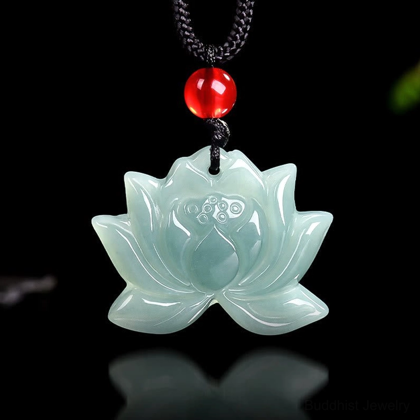 Lotus jade Buddhist pendant with intricate seed pod carving at center, pale green jade tone front view
