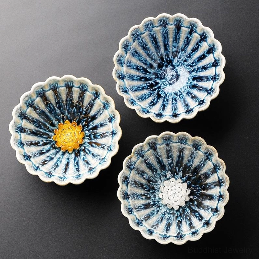 Set of three lotus jian zhan buddhist tea cups with scalloped petal rim design on display
