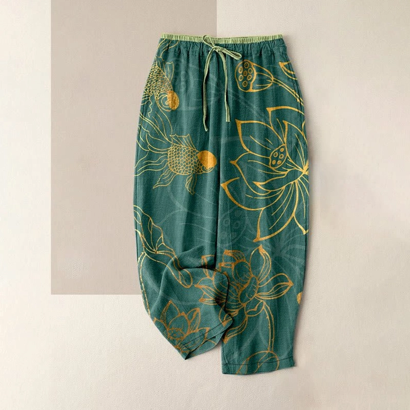 Dark green lotus and koi fish print cotton harem pants flat lay front view, featuring elastic drawstring waist and deep pockets for women's casual wear