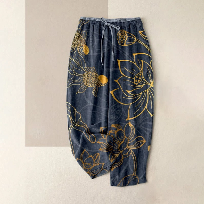 Navy blue lotus and koi fish print cotton harem pants flat lay front view with elastic waist, showing full casual pants silhouette