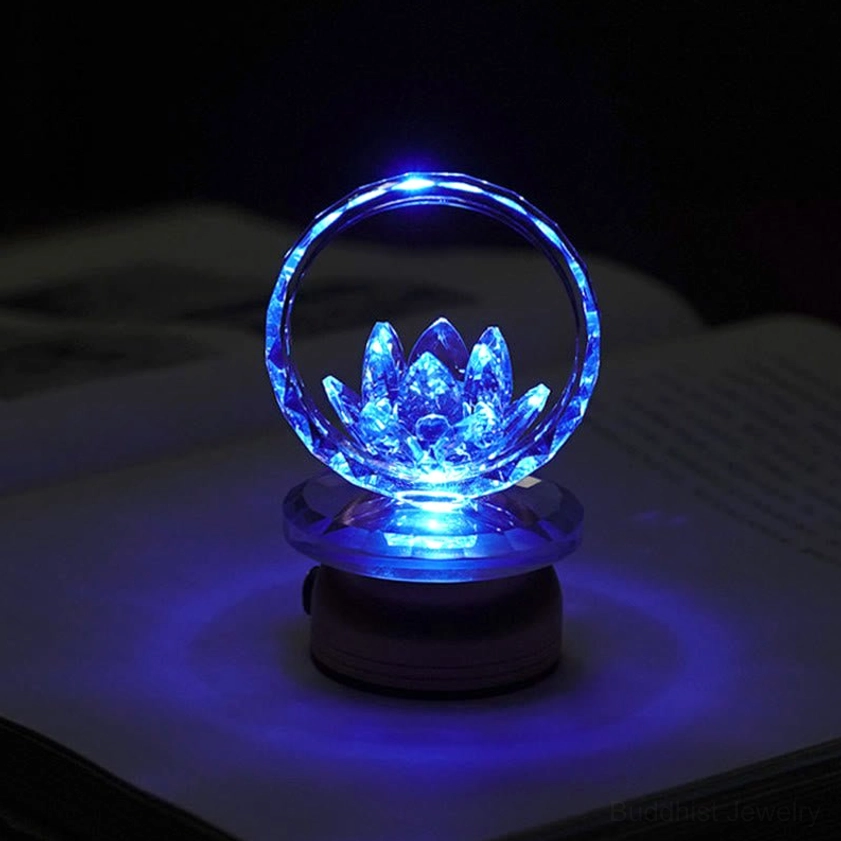 Blue glowing crystal lotus with faceted hoop and dark base, meditation ambiance lighting