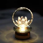Lotus crystal LED table lamp with warm golden glow and copper brass base, intimate meditation ambiance