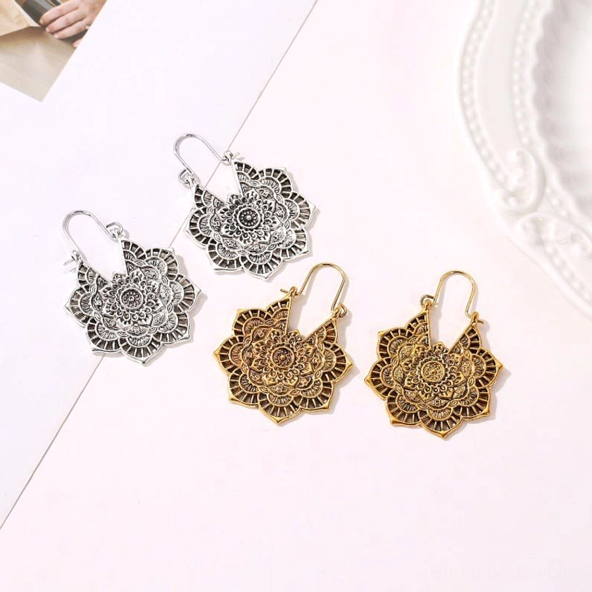 Buddhist lotus mandala earrings in both gold and silver finishes showing hollow filigree design options