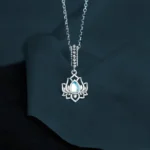 925 sterling silver lotus moonstone necklace pendant with iridescent moonstone in hollow lotus design against dark background