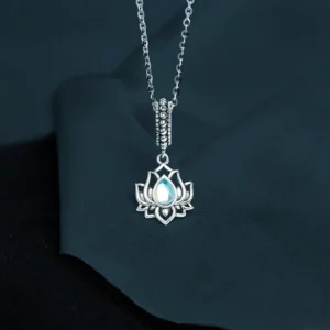 925 sterling silver lotus moonstone necklace pendant with iridescent moonstone in hollow lotus design against dark background
