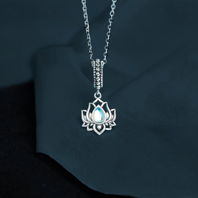 925 sterling silver lotus moonstone necklace pendant with iridescent moonstone in hollow lotus design against dark background