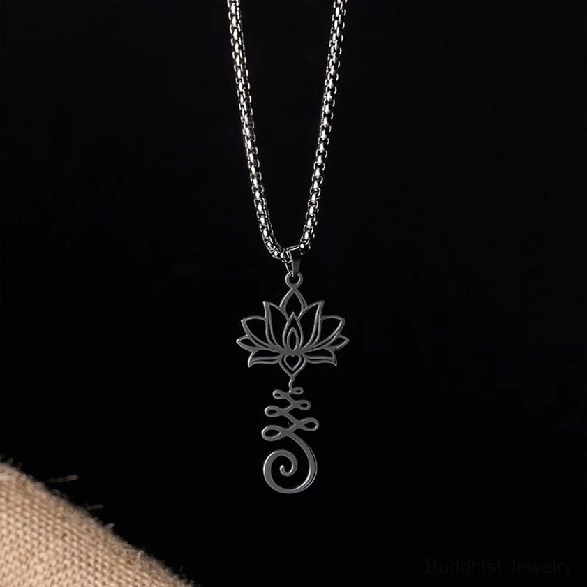 Gold lotus pendant necklace showing wearable perspective with hand-held display of detailed hollow carving