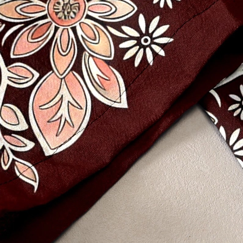 Detailed lotus and paisley floral pattern on burgundy cotton harem pants with soft pink accents