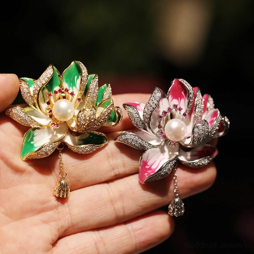 Pair of lotus pearl brooches side by side - green and rose red variants with central pearls