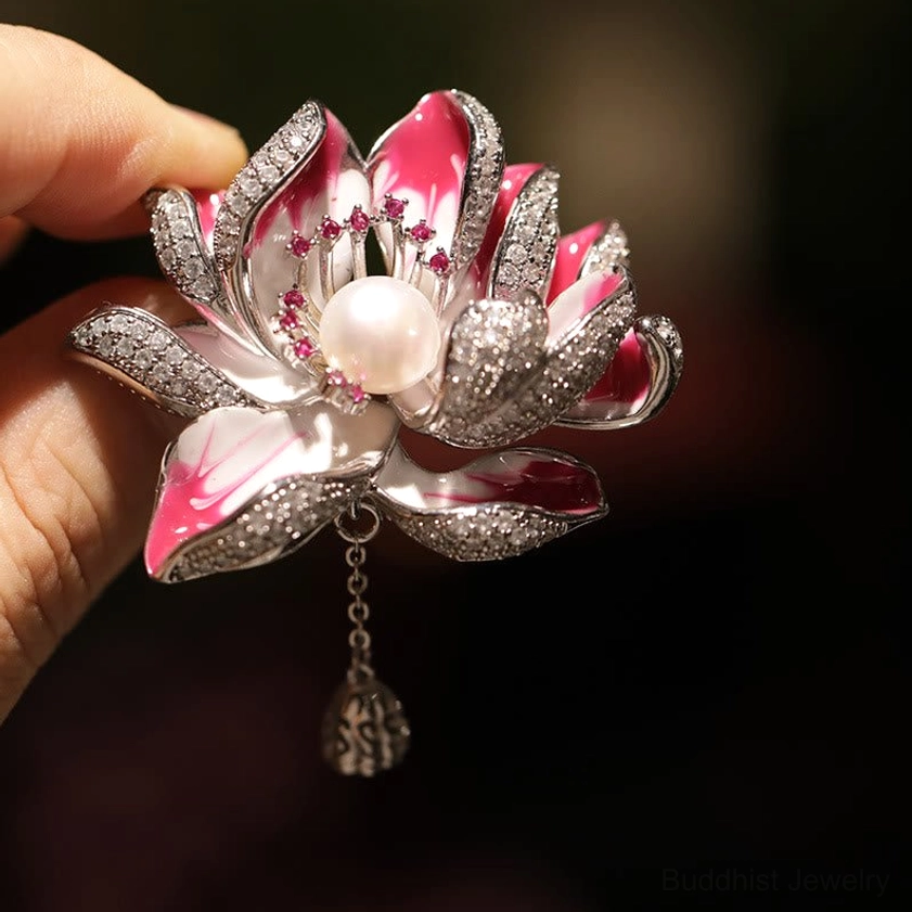 Pink-white lotus brooch with diamond pavé accents, front close-up with hanging crystal pendant