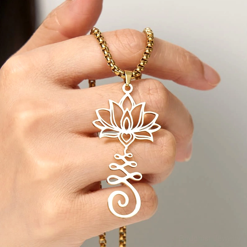 Black stainless steel lotus symbol pendant with hollow carving design displayed at upper side angle