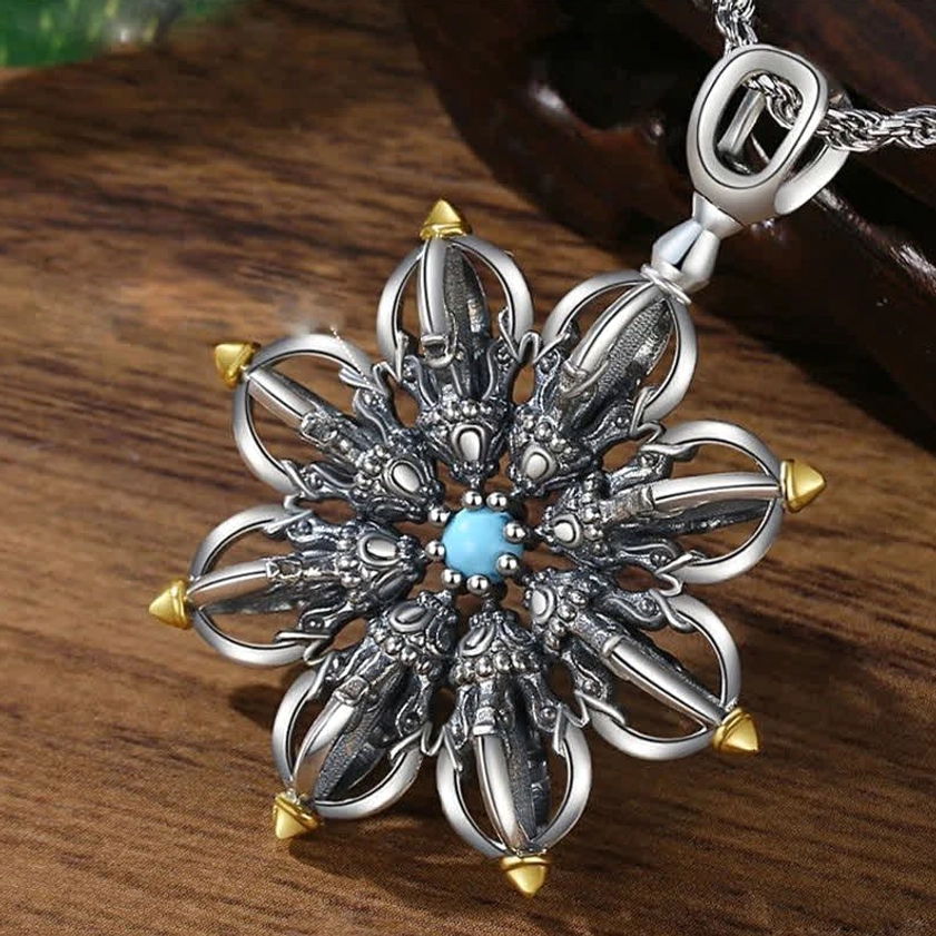 Handcrafted lotus pendant with silver metal and gold tips, close-up showing intricate carved work