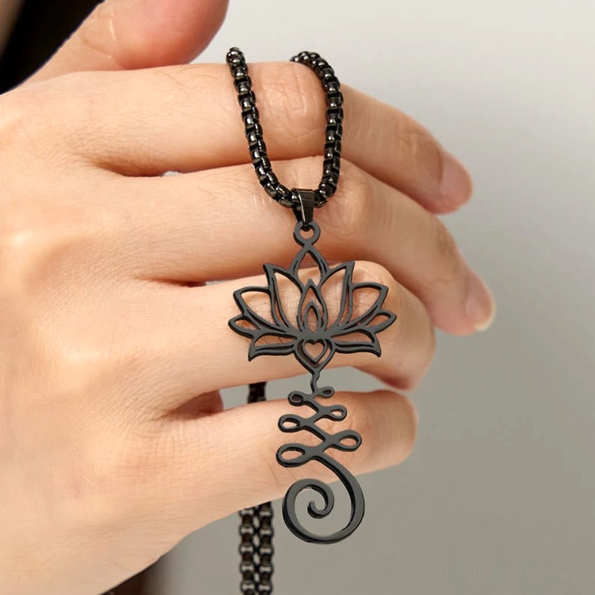 Gold lotus Buddhist spiritual pendant necklace displayed in hand showing wearable size and detailed carving pattern