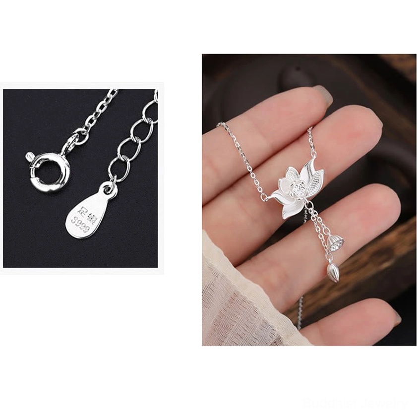Sterling silver lotus tassel necklace held in hand against dark wooden background, showing pendant movement and craftsmanship