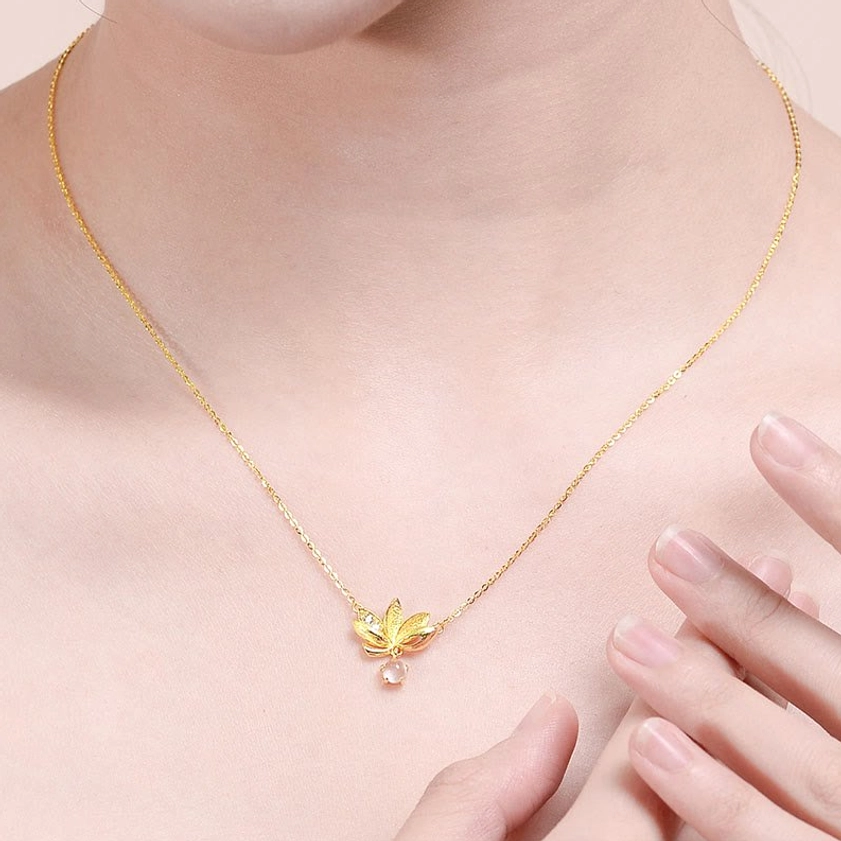 Wearing view of delicate sterling silver lotus necklace on collarbone and neck close-up
