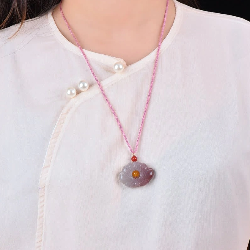 Lotus flower jade necklace worn on model with traditional inspired styling