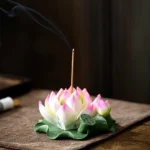 Lotus Pink Edge handcrafted ceramic incense burner with smoking incense stick on wooden surface