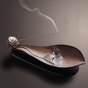 Handcrafted lotus pod ceramic incense burner with embossed lotus relief, brown matte finish, studio view