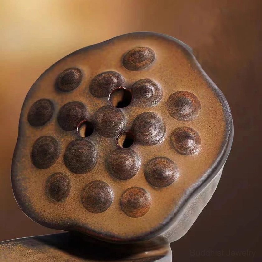 Lotus pod incense holder in zen meditation setting, brown ceramic with embossed lotus flower design