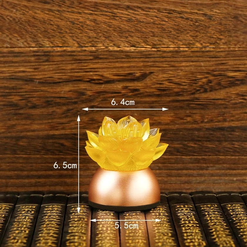 Single lotus liuli glass prayer light with dimension measurements placed on sutra scroll, flat-lay product showcase with rose-gold base