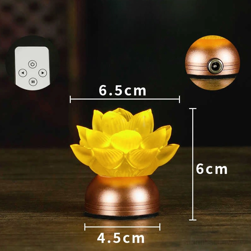 Front-on view of lotus liuli glass prayer light with exact dimension labels, warm yellow glass lotus, rose-gold copper base on wooden table