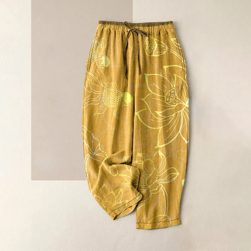 Mustard yellow cotton harem pants with pale yellow lotus print flat lay front view, featuring comfortable elastic waistband and pockets