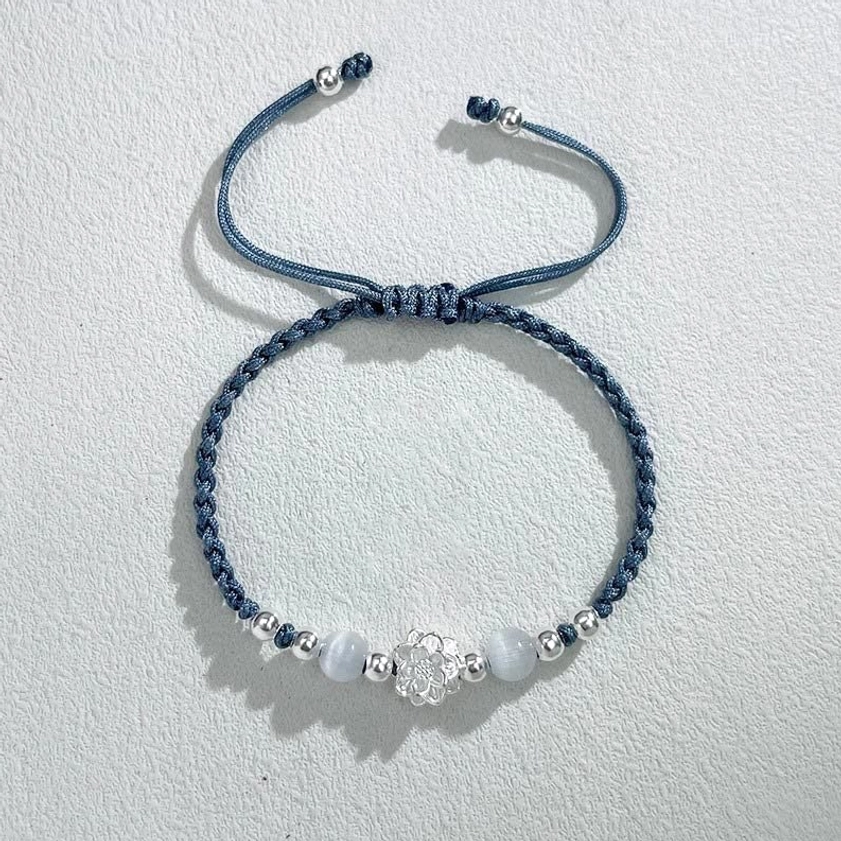 Blue lotus protection string bracelet with sterling silver accents and cat's eye gemstone detail