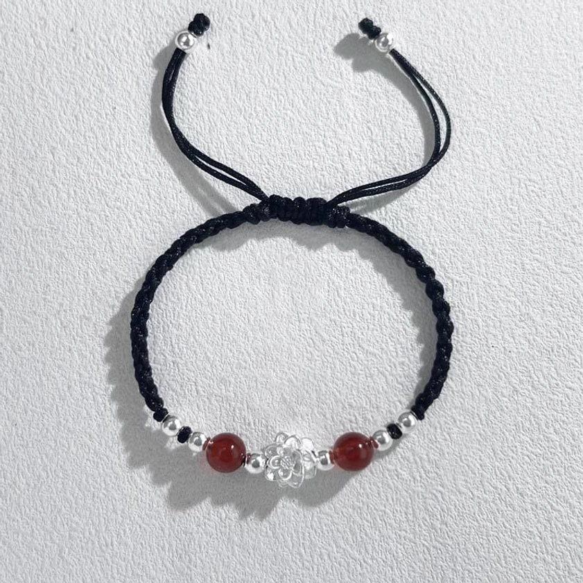 Red string lotus protection bracelet with red agate beads and silver lotus charm on black cord