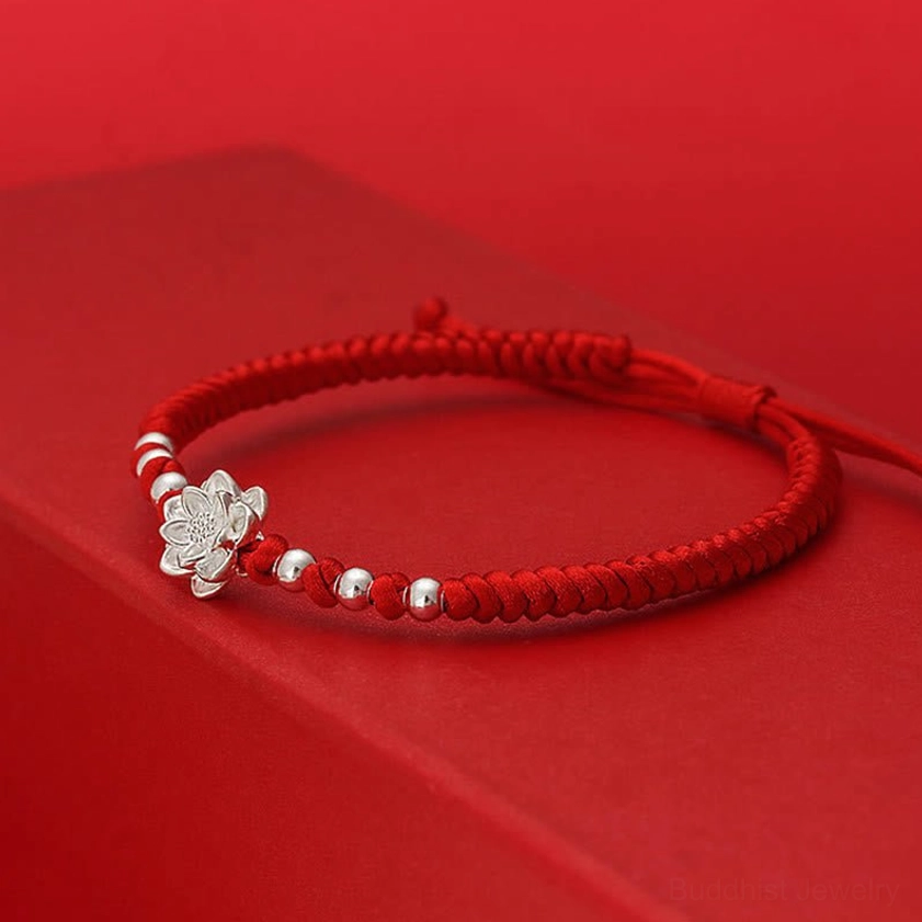 Buddhist lotus symbol red string bracelet side profile showing silver charm and spaced beads