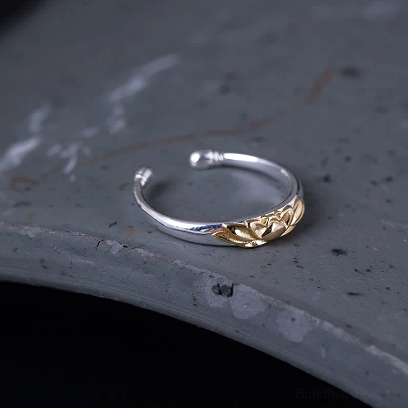 Adjustable lotus flower ring top view highlighting slim silver open band with gold lotus embossed detail