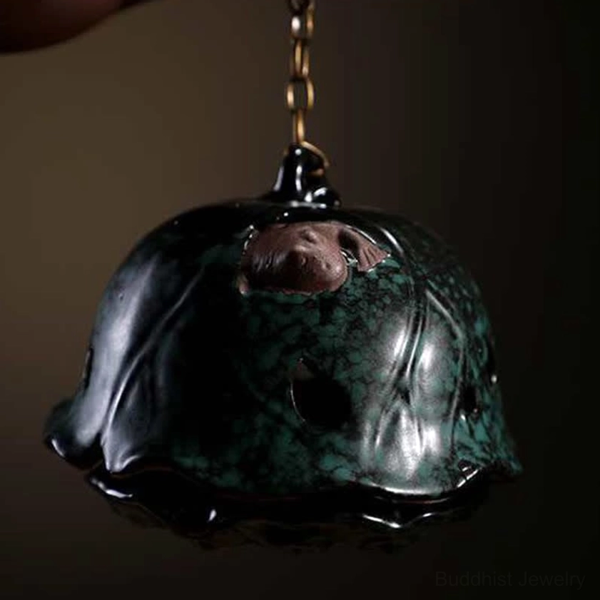 Lotus-shaped ceramic incense censer close-up dark green glaze with embossed details
