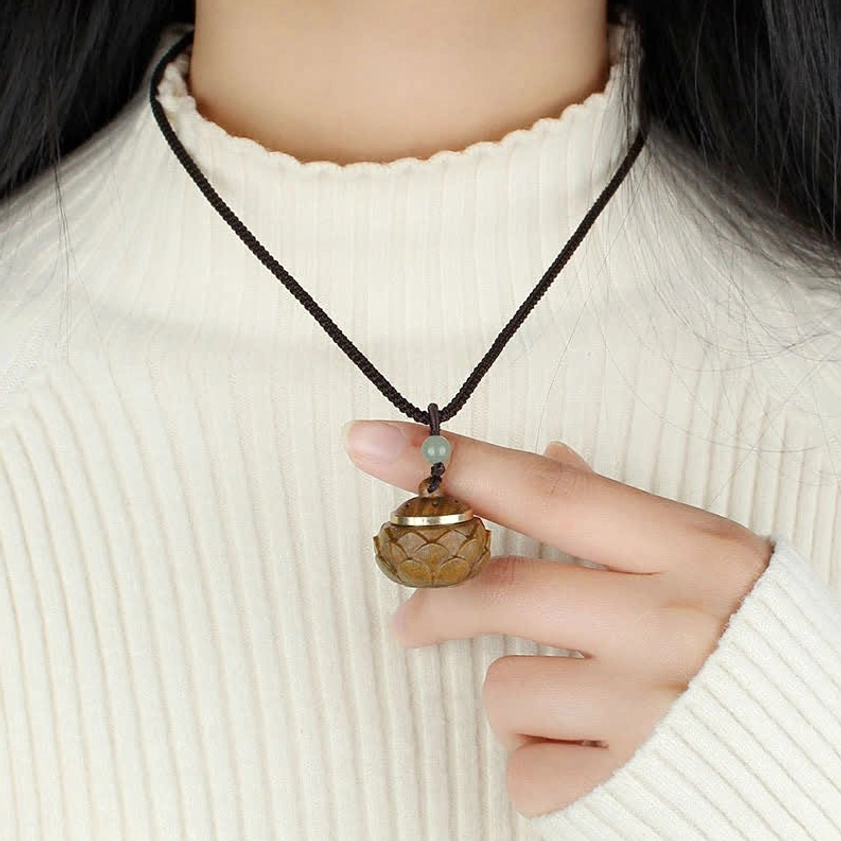 Lotus-shaped green sandalwood Buddhist incense box pendant with metal decorative rim and natural wood grain texture
