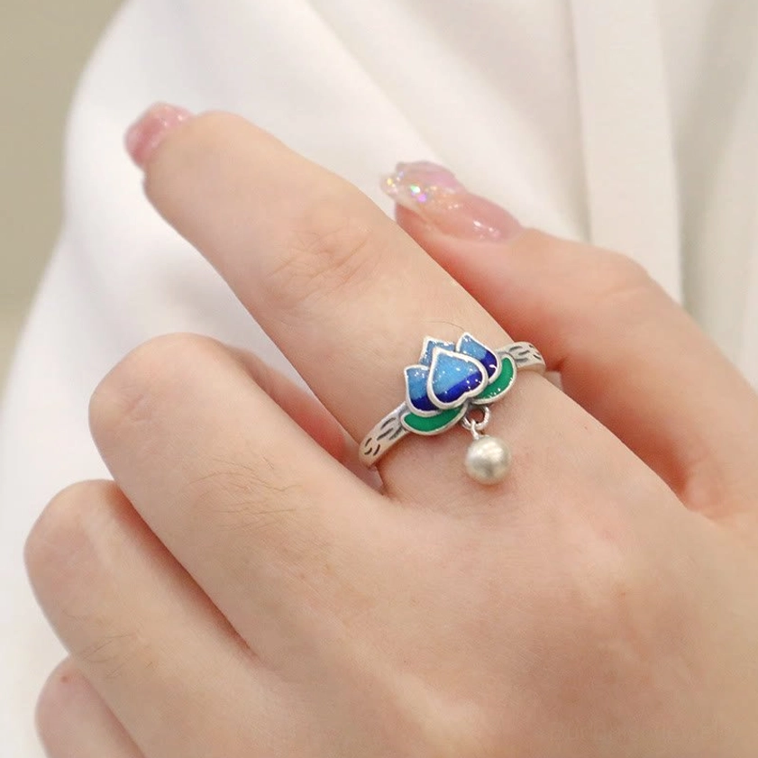 Adjustable lotus silver ring featuring detailed blue-green enamel cloisonné lotus pattern and dangling bell pendant charm