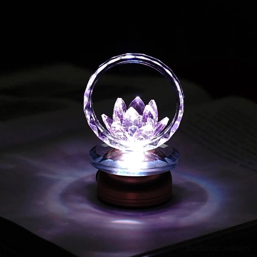 Lotus night light with warm faceted crystal hoop and copper base in dark setting