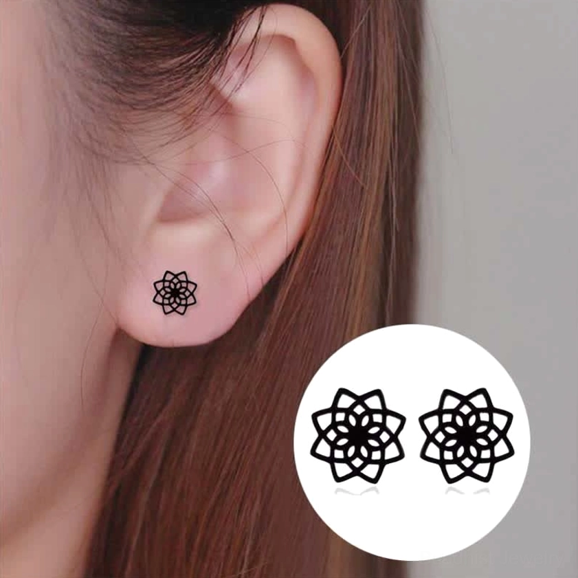 Black lotus stud earrings worn on ear close-up view showing petite size and comfortable wear with product preview