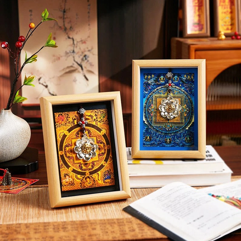 Two sacred lotus thangka photo frames with blue and golden mandala designs displayed together on home desk