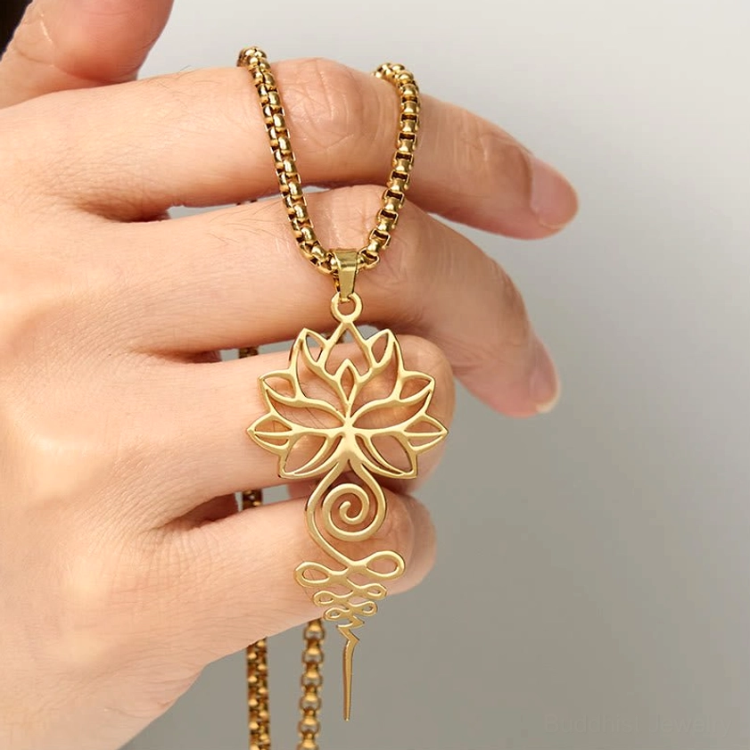 Lotus unalome Buddhist necklace detail shot showing intricate hollow filigree lotus and unalome spiral chakra pattern