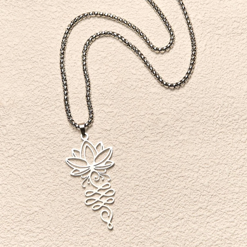 Lotus unalome chakra Buddhist necklace pendant flat lay with chain on beige wall background