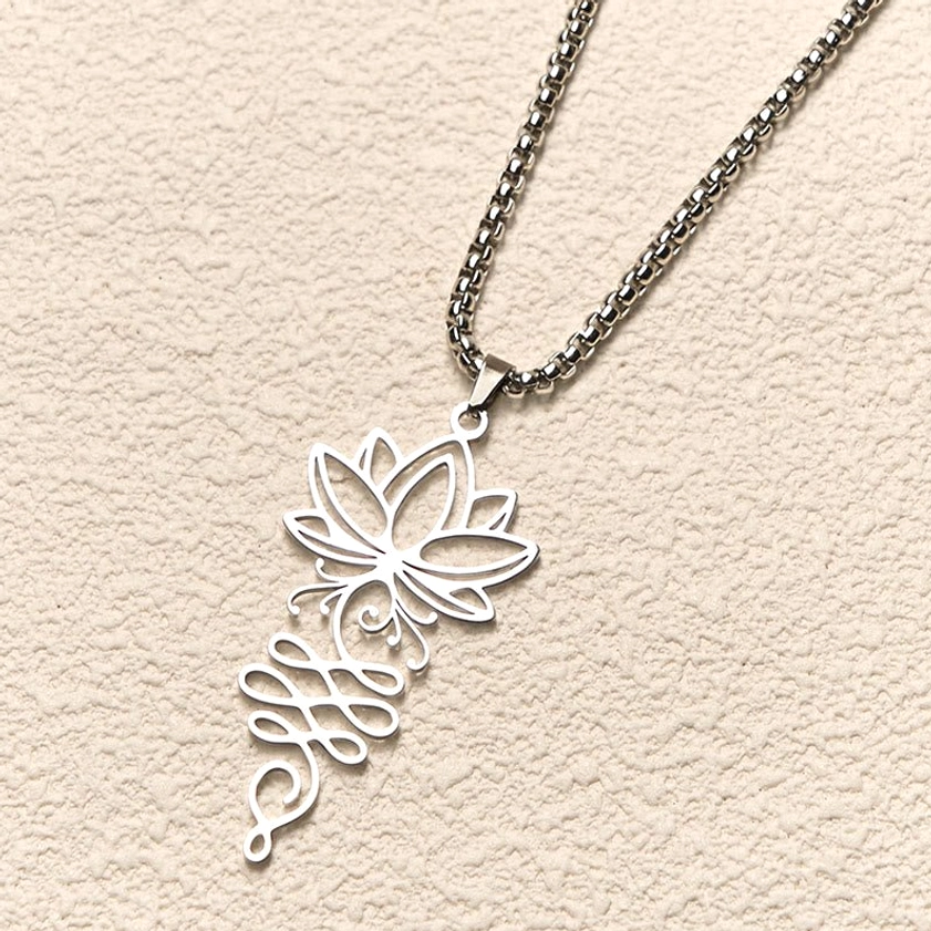 Lotus unalome spiritual necklace pendant intricate hollow carved design oblique angle beige background