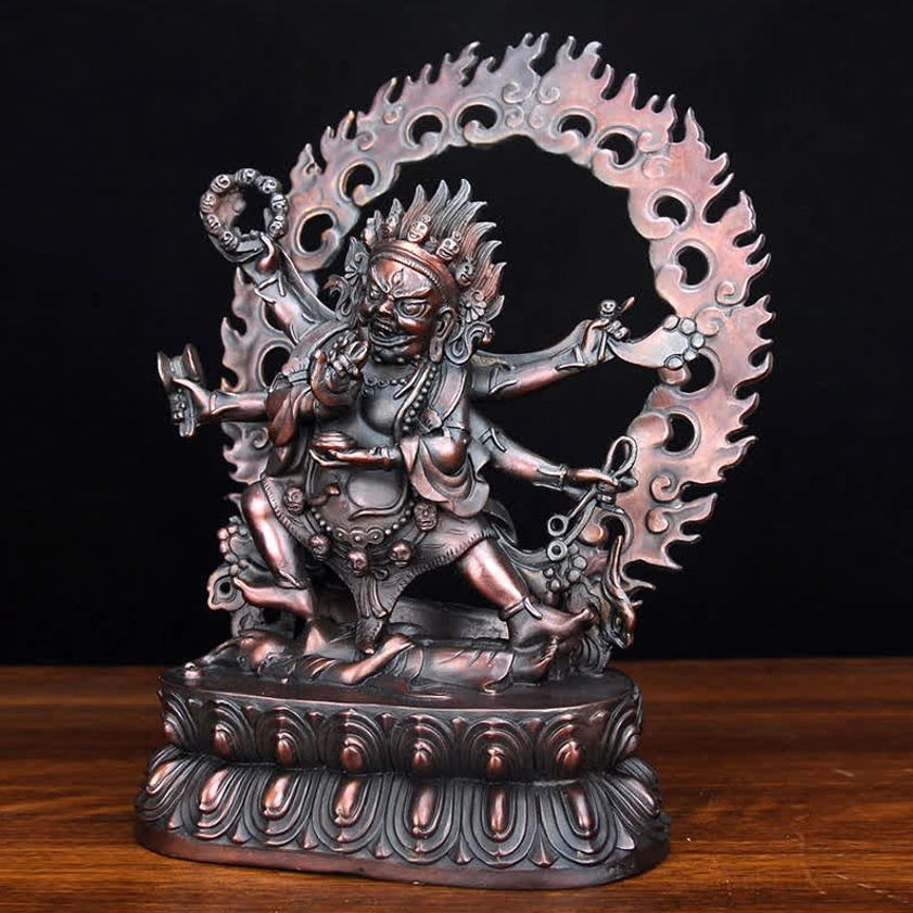 Left three-quarter view of dark copper reddish-brown Mahakala statue with multi-armed fierce protector design