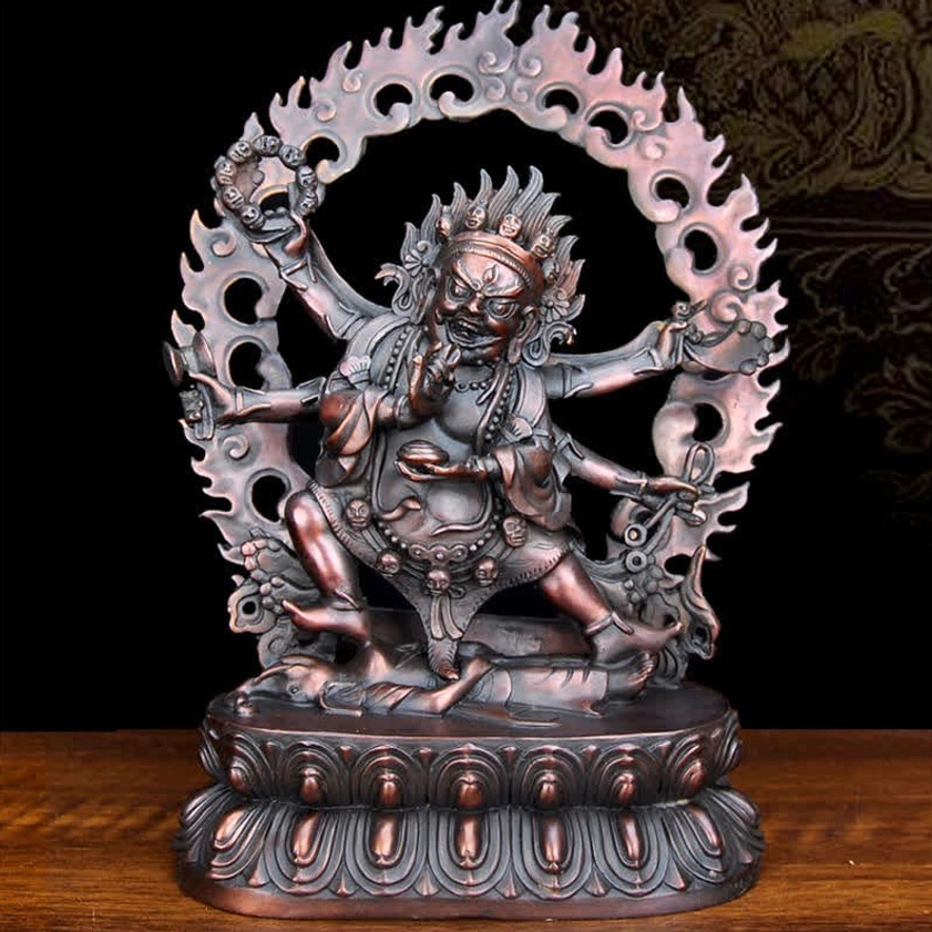 Three-quarter front angle of dark bronze Mahakala copper statue featuring ornate carved decorations and multi-armed fierce design