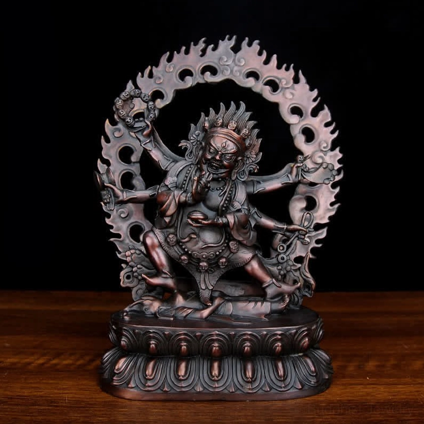 Dark reddish-brown purple oxidized Mahakala statue frontal view showing intricate fierce deity carved details and ornate design