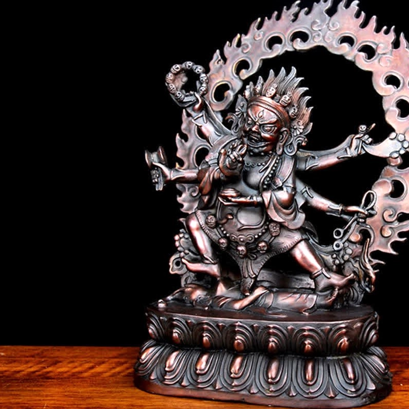 Right three-quarter front view of Mahakala six-armed statue featuring detailed lotus base and hollowed flame aureole