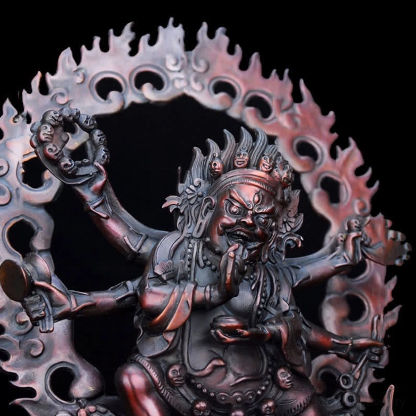 Close-up detail of Mahakala statue's intricate face and fierce compassionate expression representing spiritual power and protection