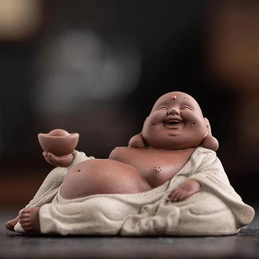 Laughing Buddha right side profile showing facial details, red forehead dot, joyful expression, holding ingot, dark background